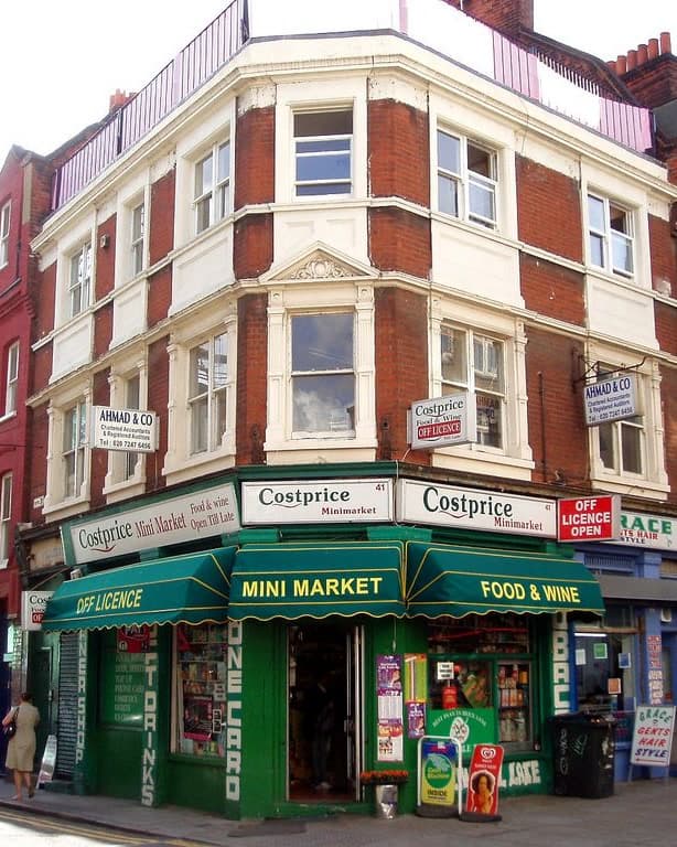 An independent corner shop on a London terrace, awnings out and the door open