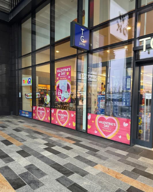 The TG Jones Yeovil storefront, campaign screens filling the windows